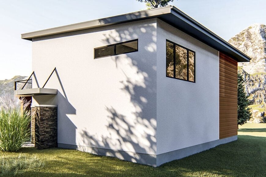 Angled rear view showing the flat rooflines, a combination of stucco and lap siding, tinted glass windows, and stone accents.