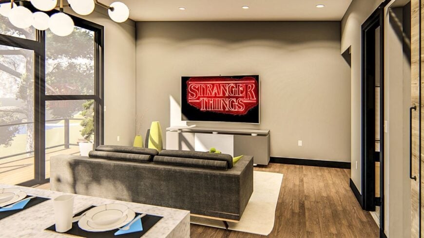 The living room has a cozy gray sofa and a flatscreen TV fixed above the modern console table.