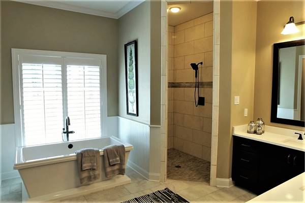 Walk-in shower and a freestanding tub complete the primary bathroom.