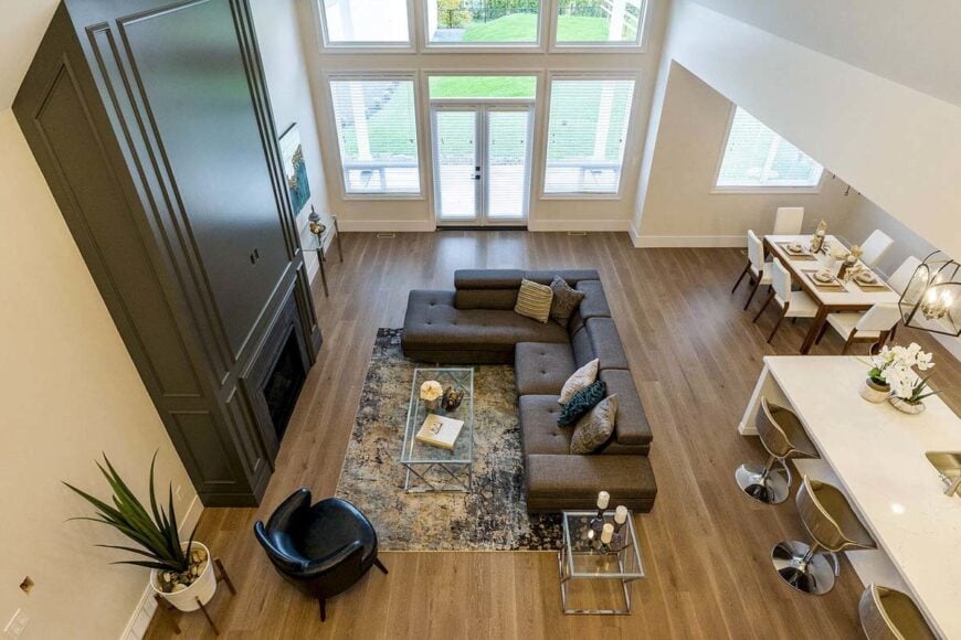 Top view of the open living space showcasing the natural hardwood flooring topped by a printed rug.
