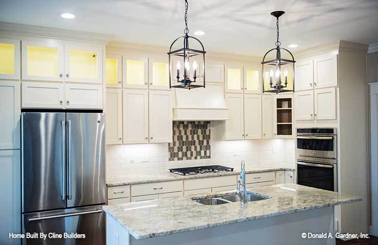 The kitchen is equipped with granite countertops, stainless steel appliances, double bowl sink, and white cabinets.