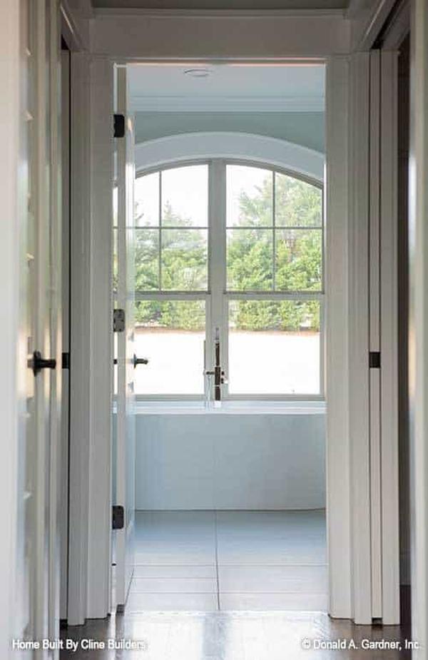 View of the primary bathroom from the walk-in closet hallway.