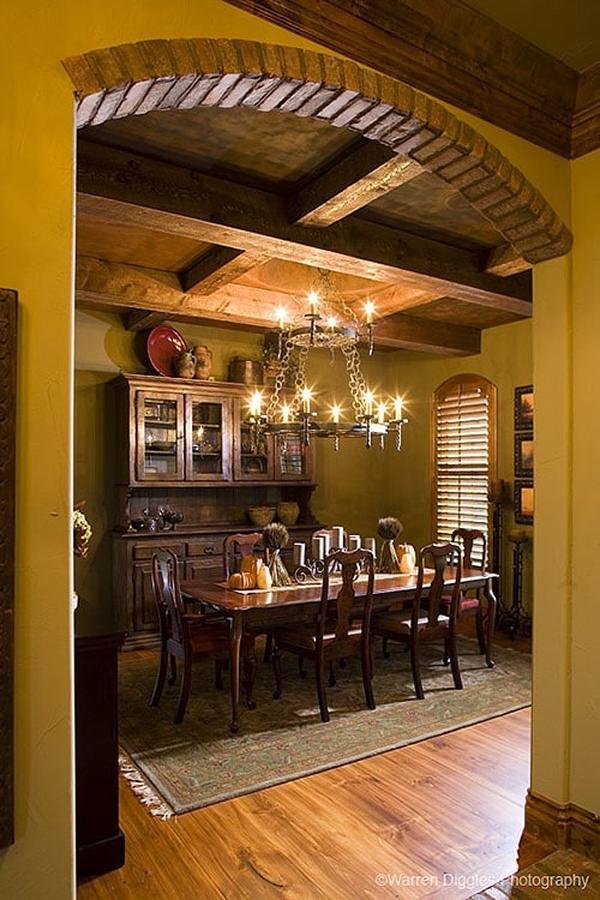 Formal dining room with coffered ceiling, dark wood dining set, and a wooden display cabinet.