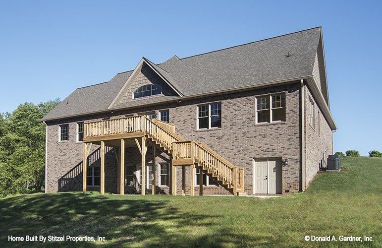 Main level floor plan of a 4-bedroom two-story The Whitford country home with great room, dining area that opens to a screened porch, kitchen, utility, And two bedrooms including the primary suite and a flexible study.
