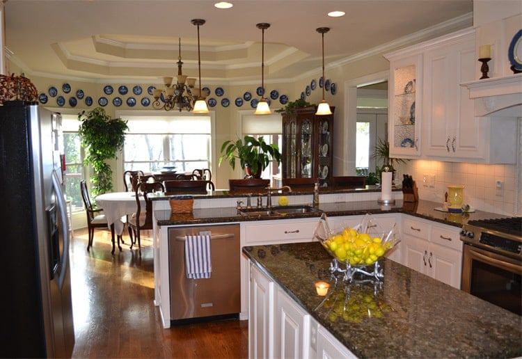 Across the kitchen is the dining area crowned with a stunning step ceiling.