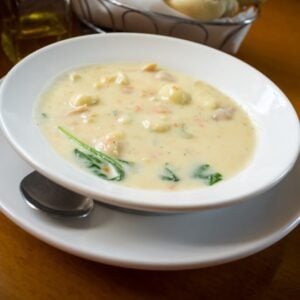 A bowl of creamy chicken and gnocchi soup.