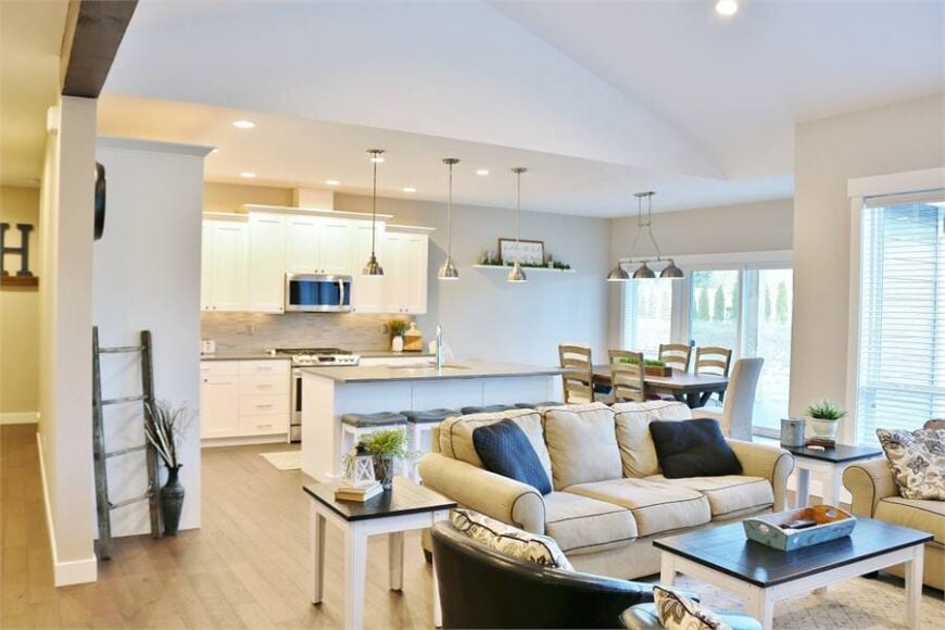 An open layout view showing the living room, kitchen, and dining area.