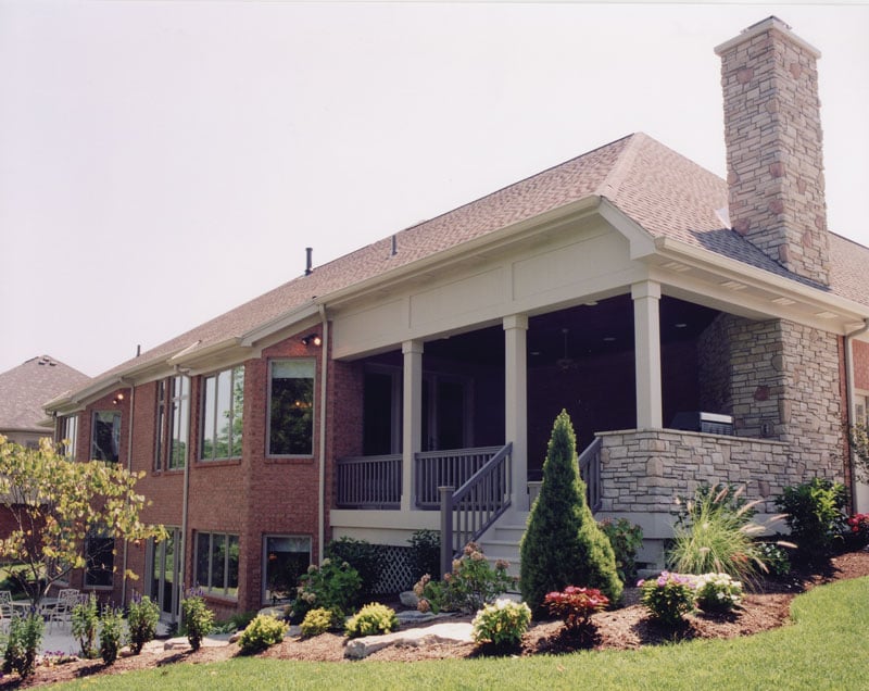 Rear exterior view showing the covered deck situated in a sloping lot.