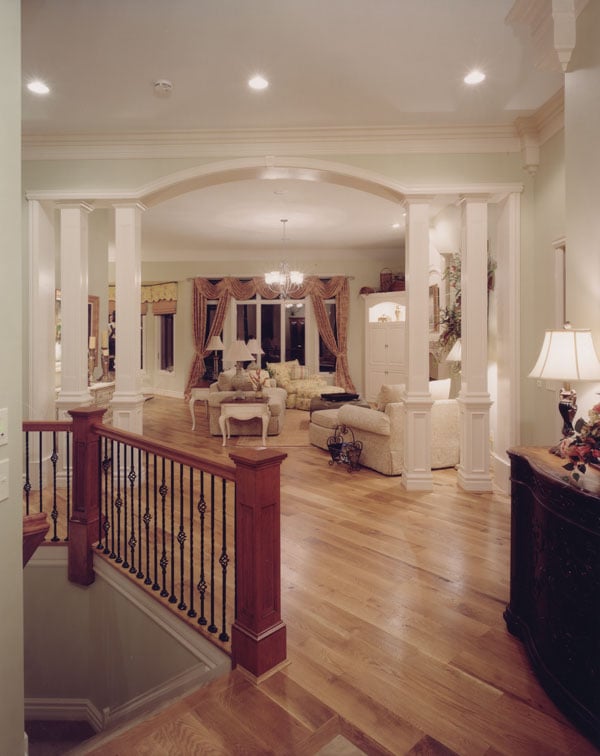 Entry hallway leading to the living room that's defined with interior columns.