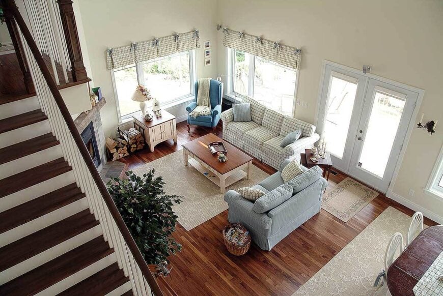 Top view of the living room showing the hardwood flooring and a french door that leads out to the porch.