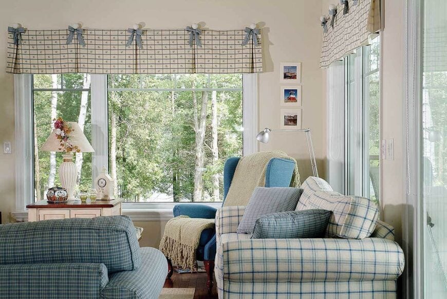 Checkered seats, a blue wingback chair, and a wooden side table complete the living room.