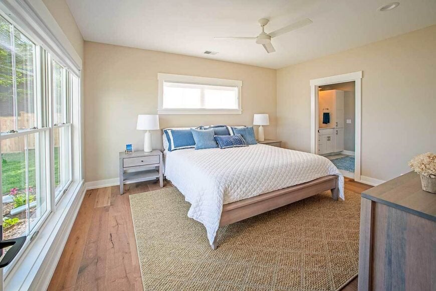 Primary bedroom with a private ensuite and a cozy wooden bed flanked by matching nightstands.