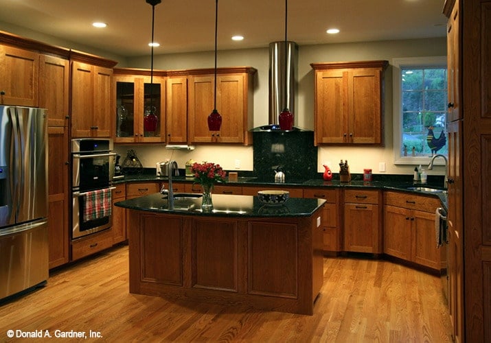 Small pendants along with recessed ceiling lights illuminate the kitchen.