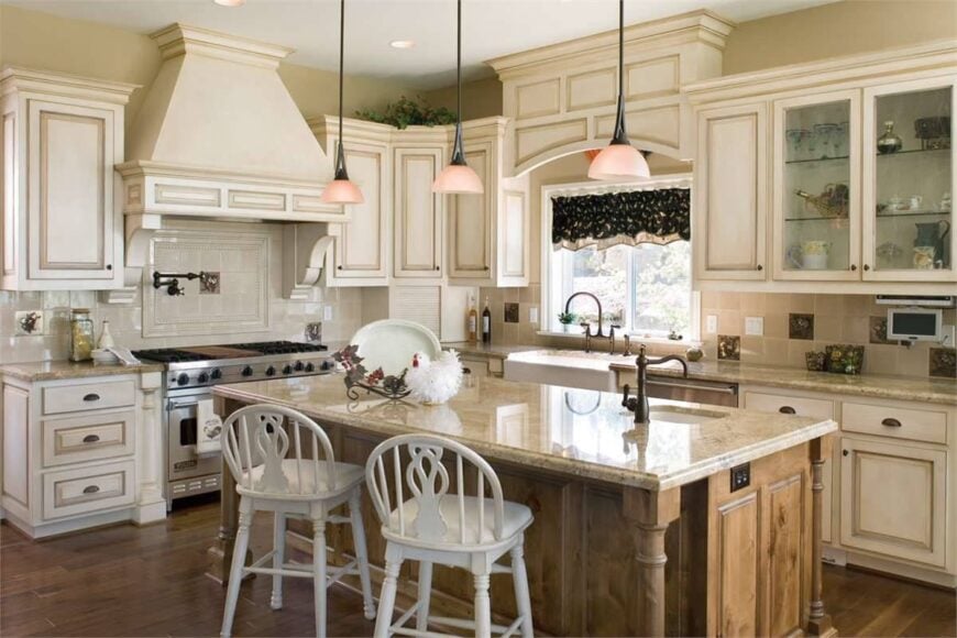 Kitchen with white cabinetry, farmhouse sink, and a breakfast island.