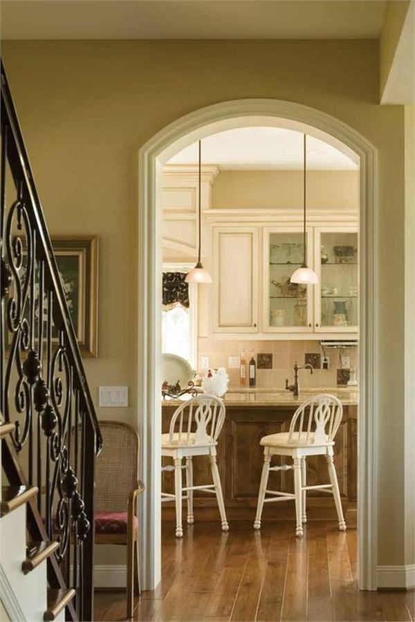 Hallway with an arched doorway leading to the kitchen.