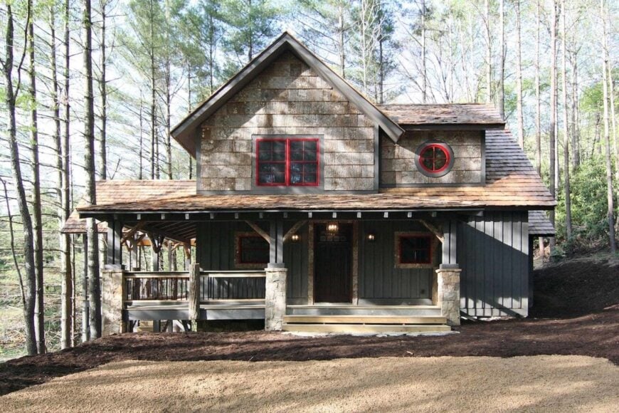 Front exterior view with shed dormers and wrap-around porch bordered by tapered columns.