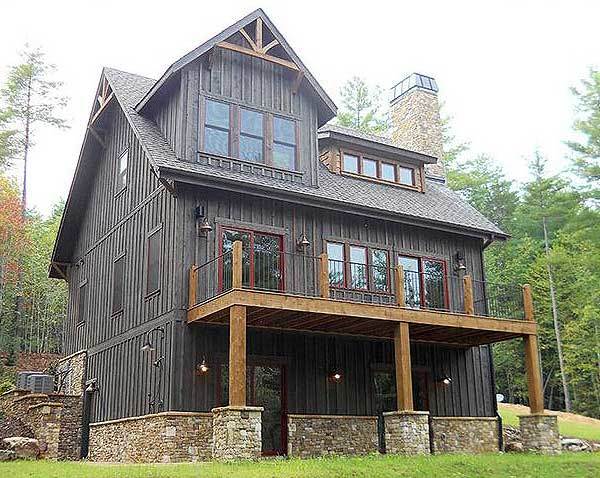 Rear exterior view showing the stone bases and an upper deck supported by wooden columns.
