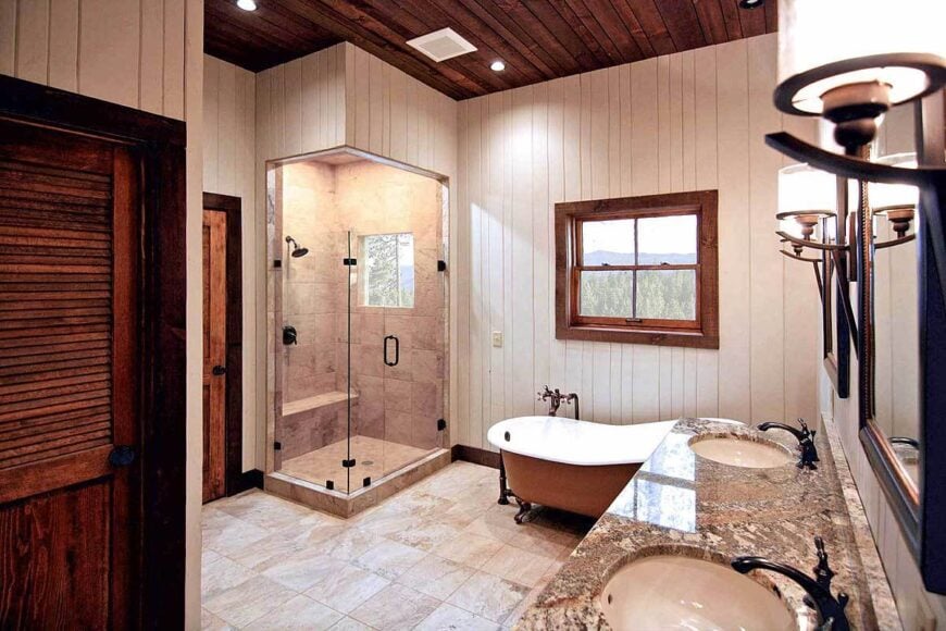 The primary bathroom has a dual sink vanity, a freestanding tub, shower area, and walk-in closet.
