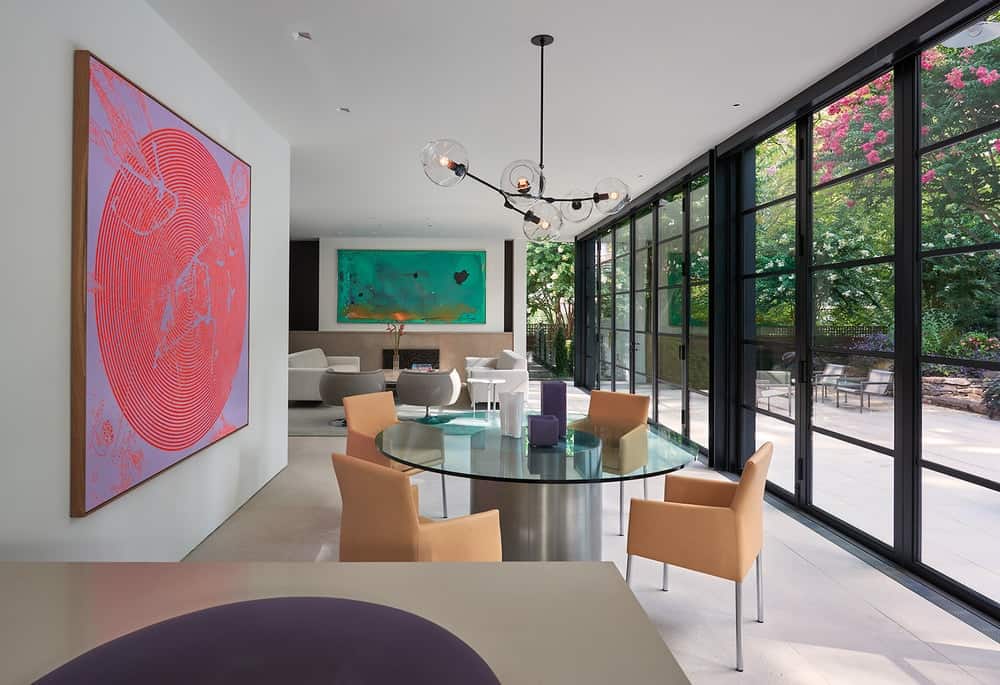 A few steps from the living room is the dining area with a large glass-top dining table.