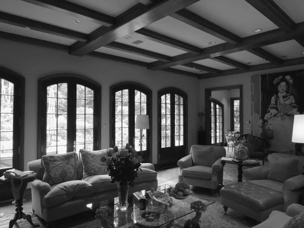 This is another angle of the old living room with a row of arched glass doors on one side leading to the back.