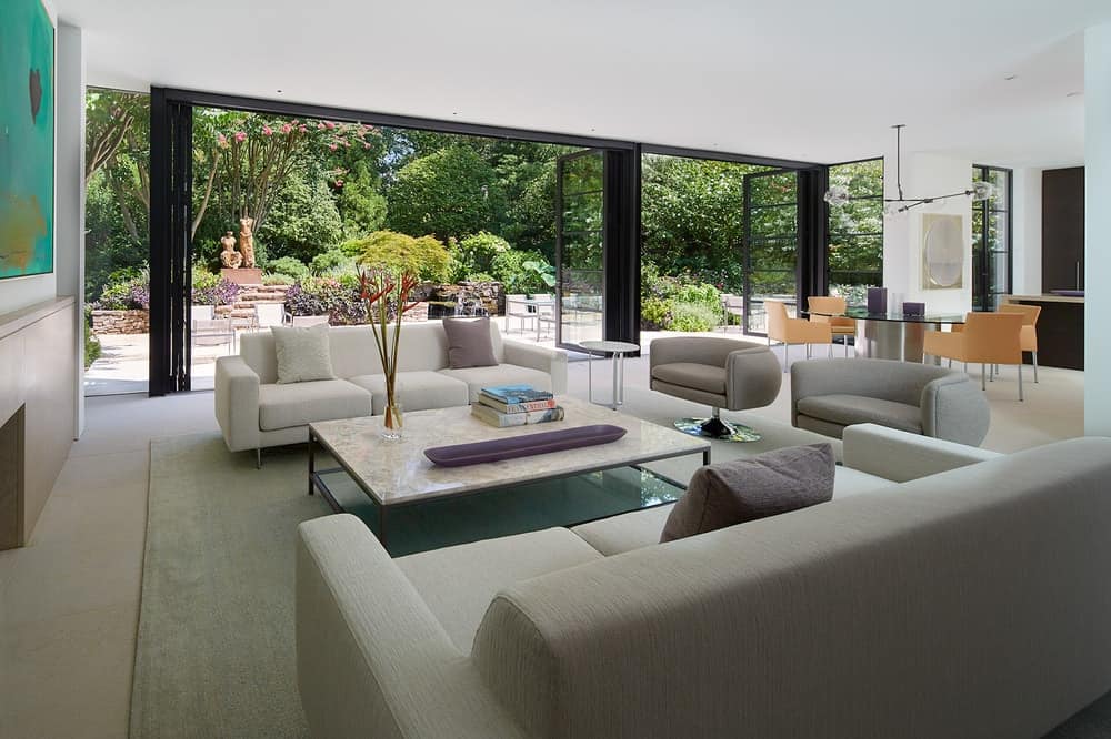 One side of the living room opens up with retractable glass doors that lead to the backyard.