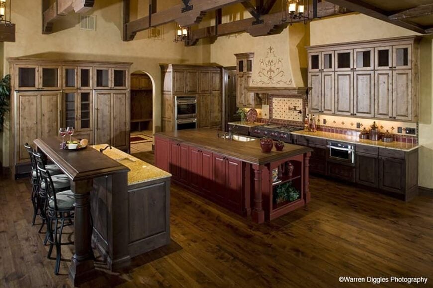 Kitchen with two islands and light wood cabinetry that blends in with the hardwood flooring.