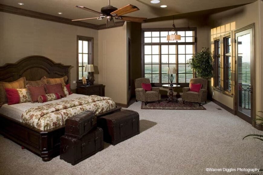 The primary bedroom has carpet flooring, a sitting area, and private access to the rear deck.