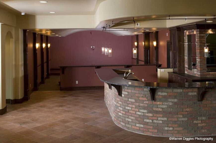 Recreation room with a large wet bar. A peninsula across defines the home theater.