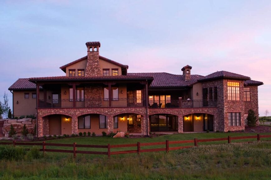 Rear exterior view showing the upper deck and covered patio framed with open archways.