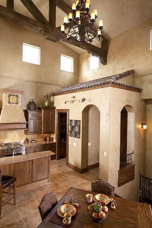 A farther view shows the vaulted ceiling and dining area with a wooden dining set.