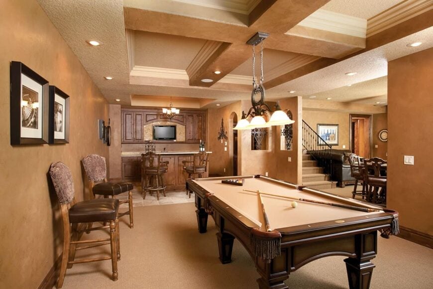 Game room with coffered ceiling, billiard table, a wet bar, and a wine cellar.