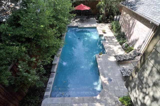 Aerial view of the backyard pool complemented with cushioned loungers.