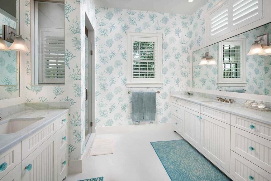 The primary bathroom has beadboard vanities, a walk-in closet, and patterned wallpaper.