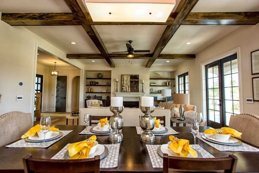 View of the living room from the dining area showcasing its wooden coffered ceiling.