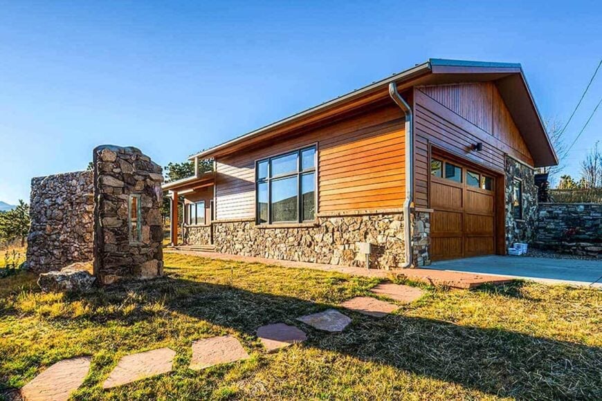 The stone walkway over the expansive lawn leads to the double garage.