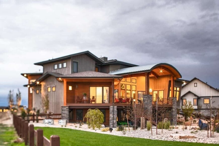 Angled rear view showing the desert garden that transitions to a lush green lawn.