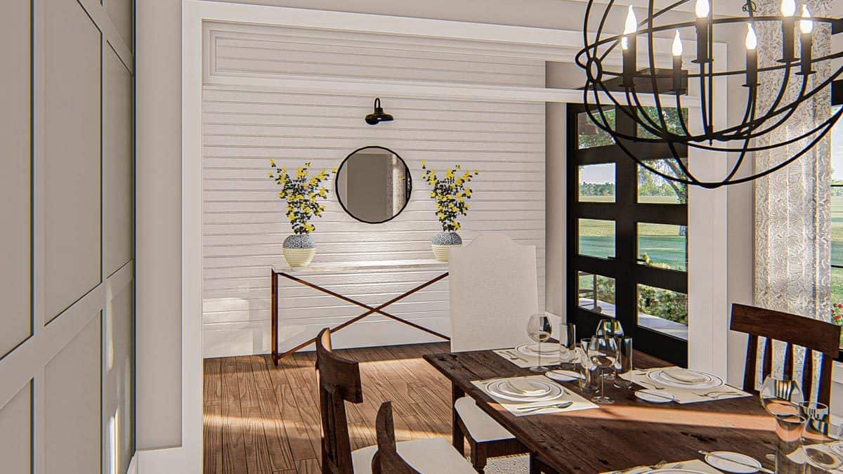 The French entry door opens to the foyer with a round mirror and a sleek console table topped with flower vases.