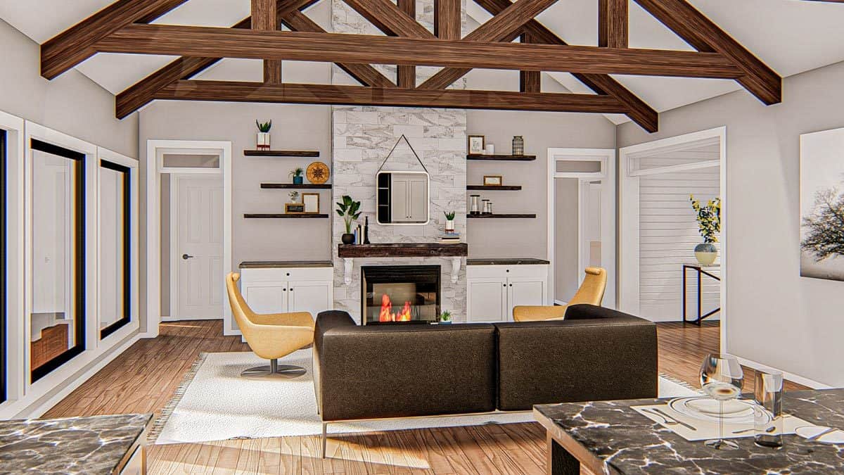 Living room with brown sofa, contemporary chairs, a marble fireplace, and a cathedral ceiling framed with rustic beams.