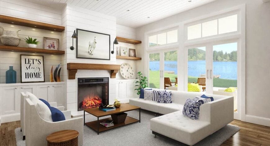 The living room has gray seats, floating shelves, wooden tables, white built-ins, and a pair of french doors that lead out to the back porch.