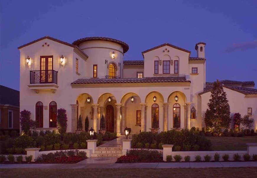 Home facade during the night showing its warm glow coming from the outdoor sconces and lamps.