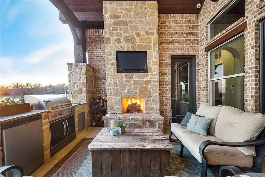 Versatile Outdoor Living Space with Fireplace and Grill