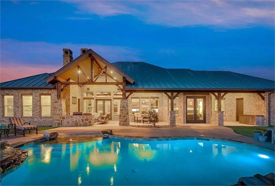 Gable Roof Patio with Illuminated Poolside View