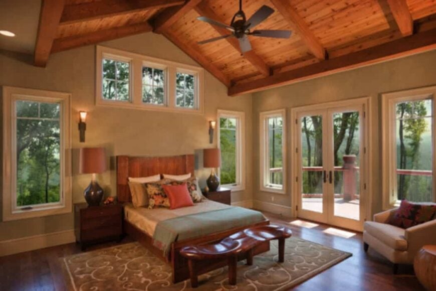 The primary suite has wooden furnishings, a cozy sitting area, and a private balcony.