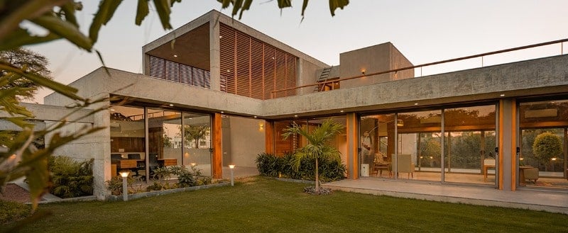 This view of the house also shows the large balcony with wooden hand rails.