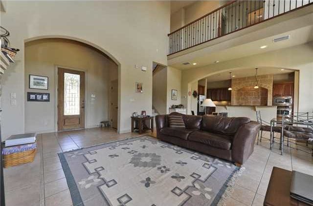 An open layout view of the foyer, living room, breakfast nook, and kitchen.