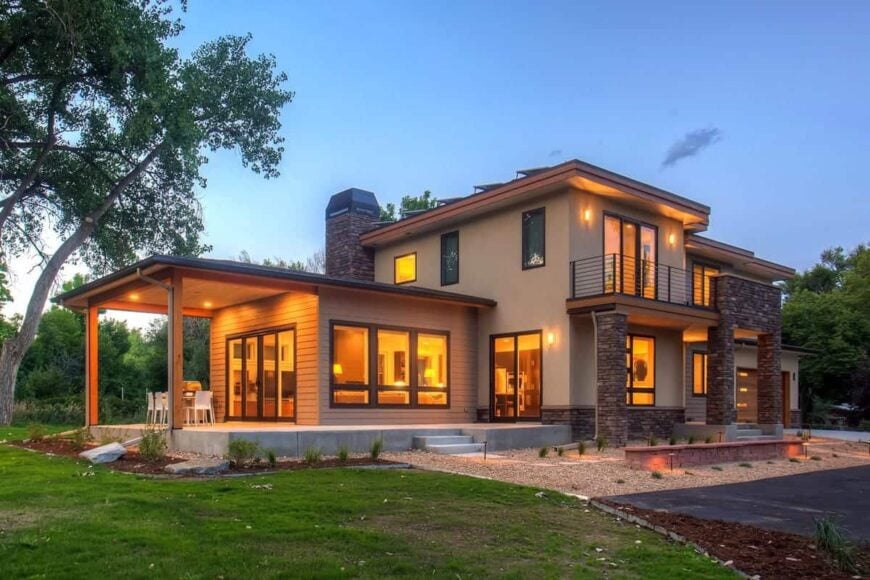 Angled front view during sunset showing its ambient lighting that floods the house.