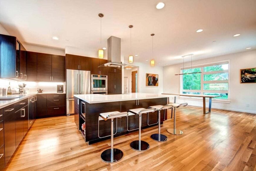 A farther view of the kitchen shows the dining area on the right side.