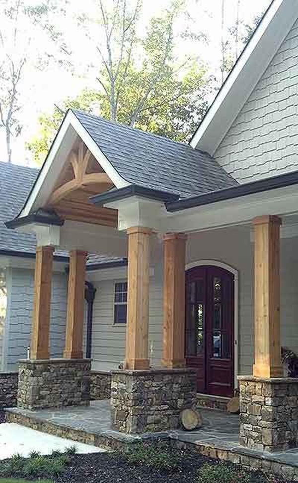 Covered front porch with flagstone flooring, double columns, and a french entry door.