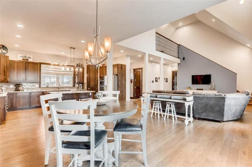 An open layout view showing the dining area, living room, kitchen, and foyer.