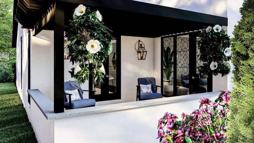 The covered porch is filled with cushioned armchairs, hanging plants, and lantern sconces.